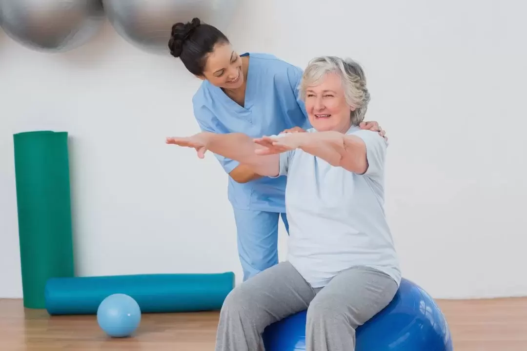 physical therapist helping elderly women with neuromuscular treatments